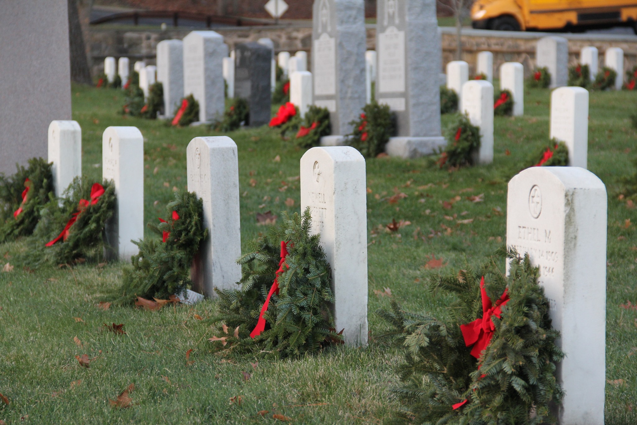 tombstones with wreaths placed on them