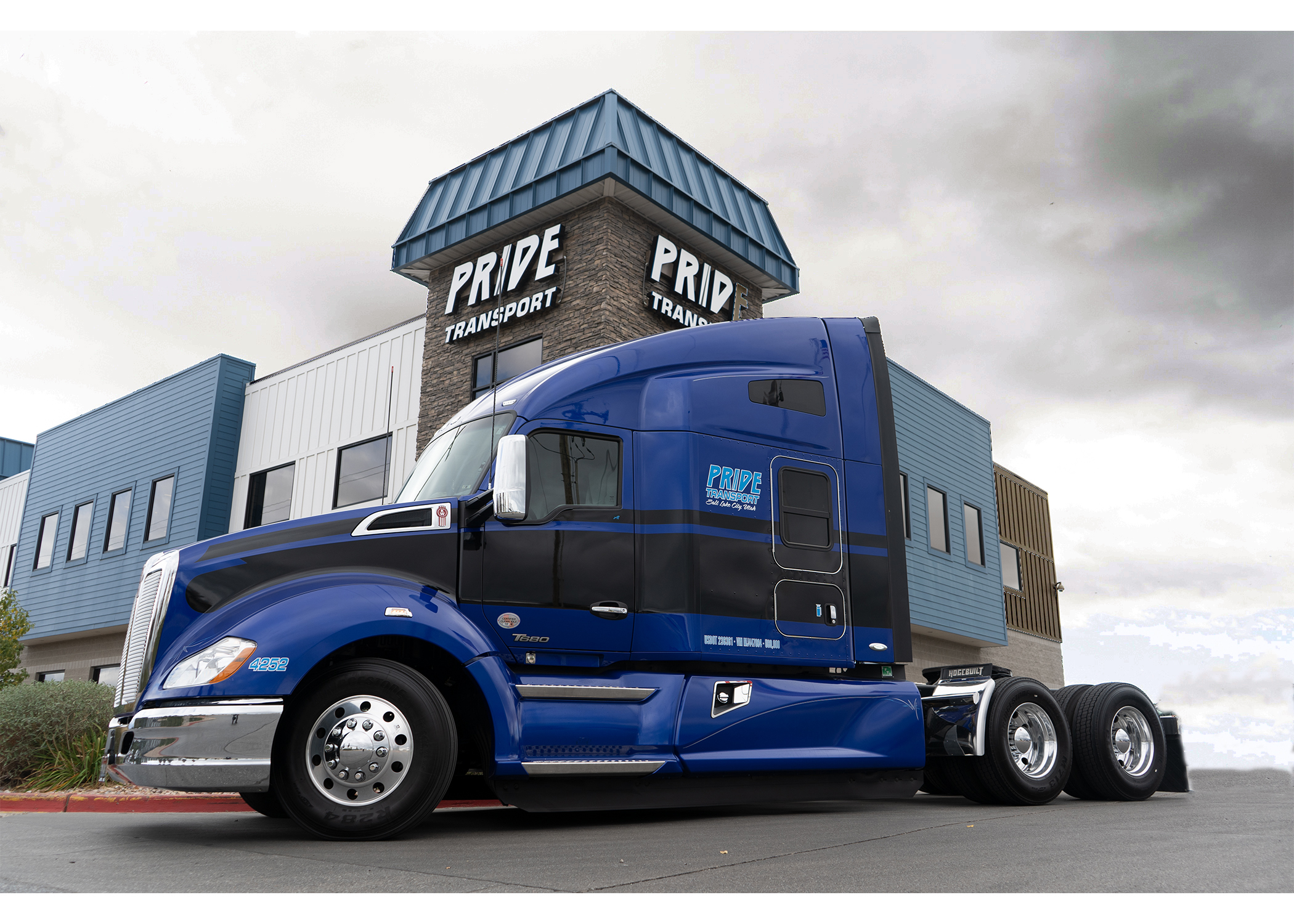 blue pride transport truck in front of headquarters