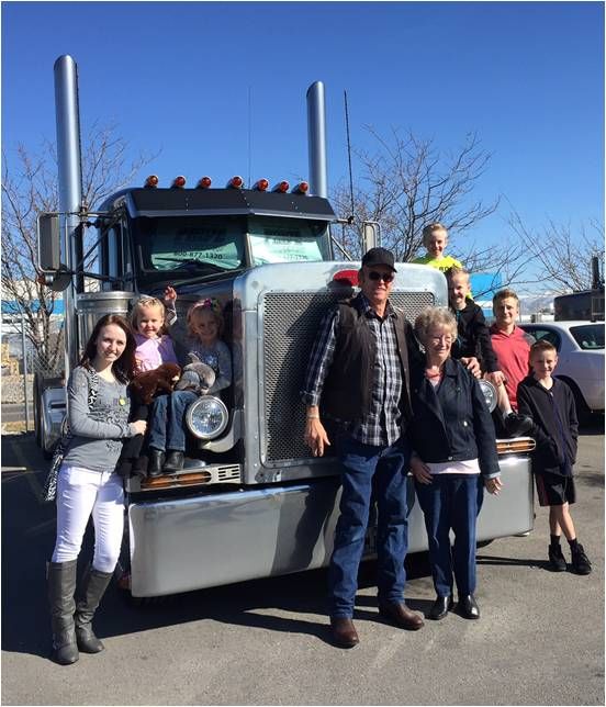 Pride Transport truck driver Bob Day and his family around his truck