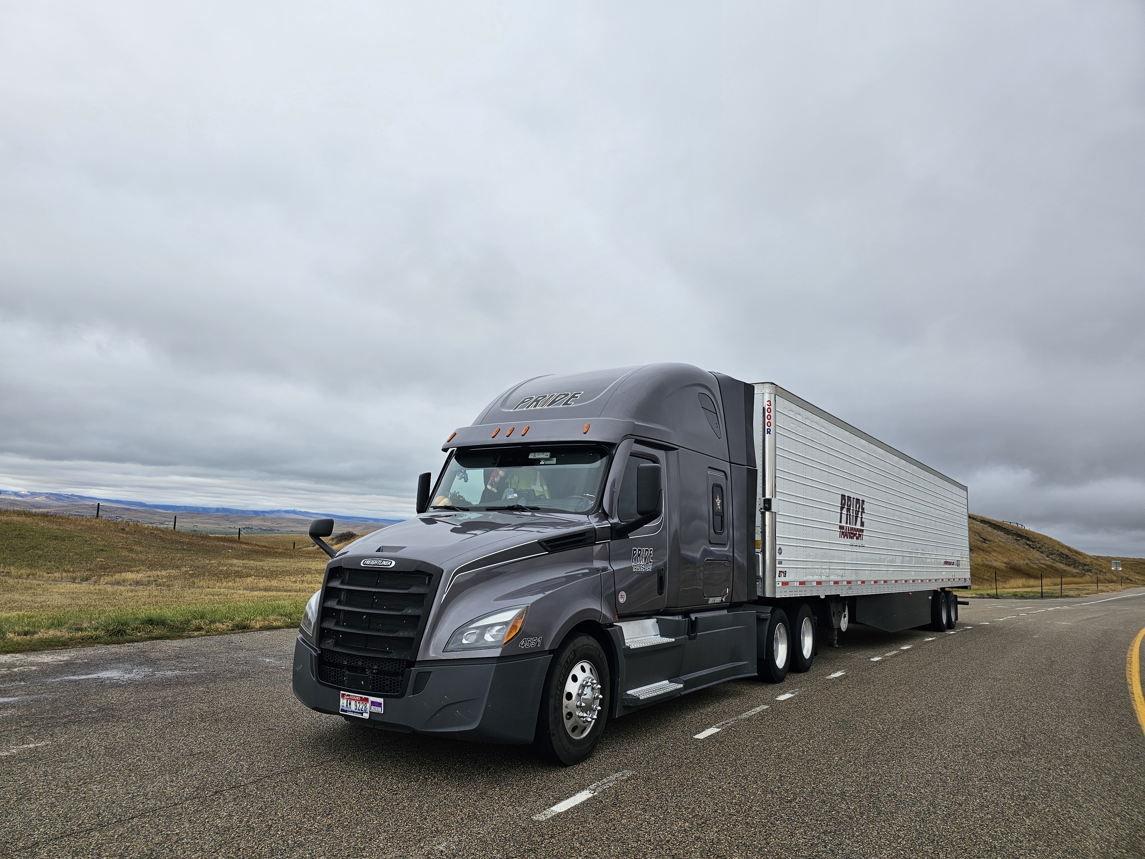 Pride Transport truck parked on shoulder of road