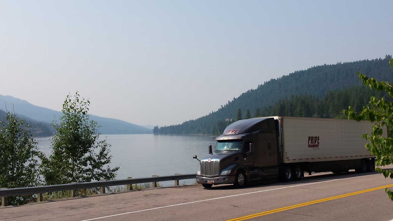 semi truck parked by a lake