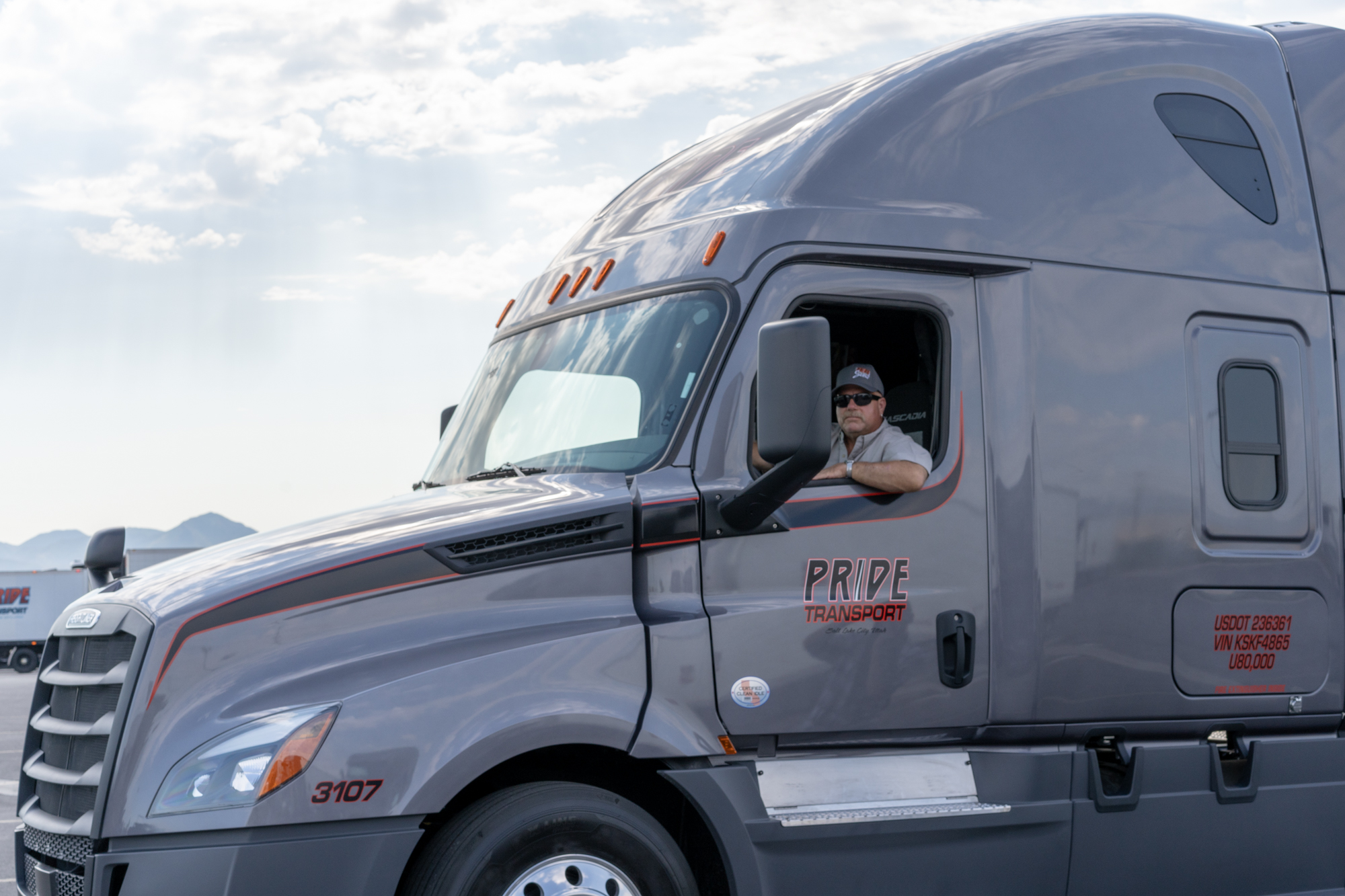 pride transport employee driving truck