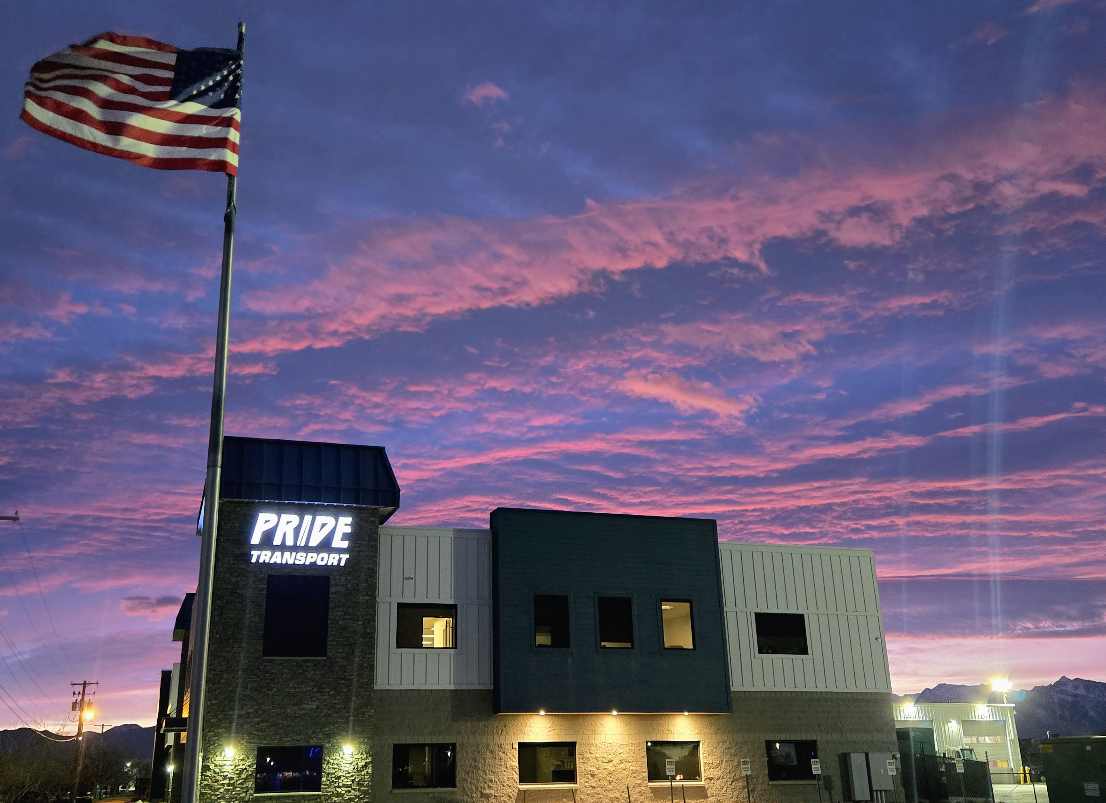 pride transport building with purple sunset in background