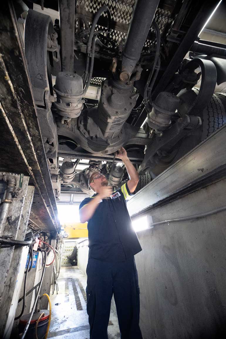 a diesel mechanic works on a semi truck