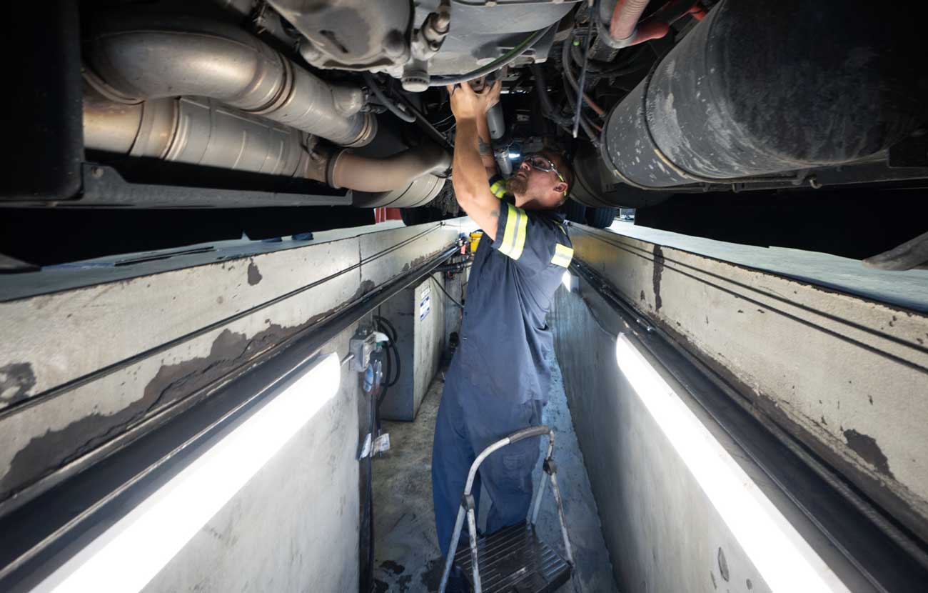 diesel technician working under a semi truck