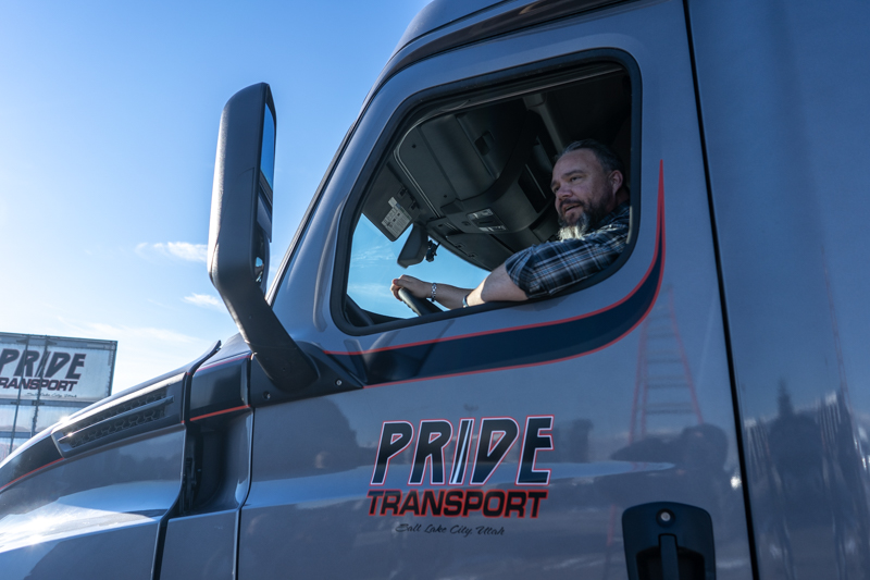 pride transport truck and employee driving