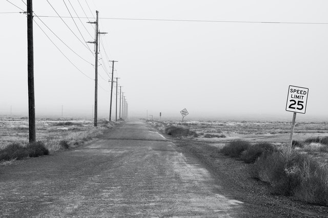 black and white dirt road and 35mph speed sign