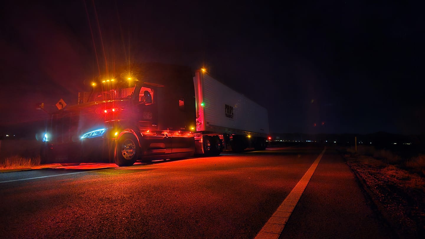 pride transport truck at night with lights