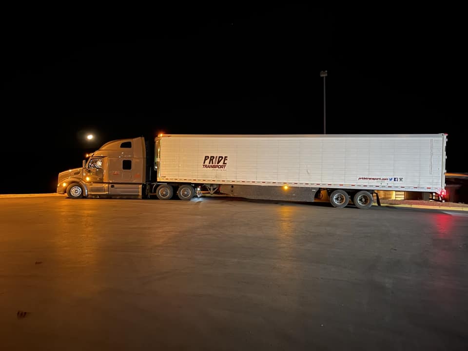 pride transport truck parked at night