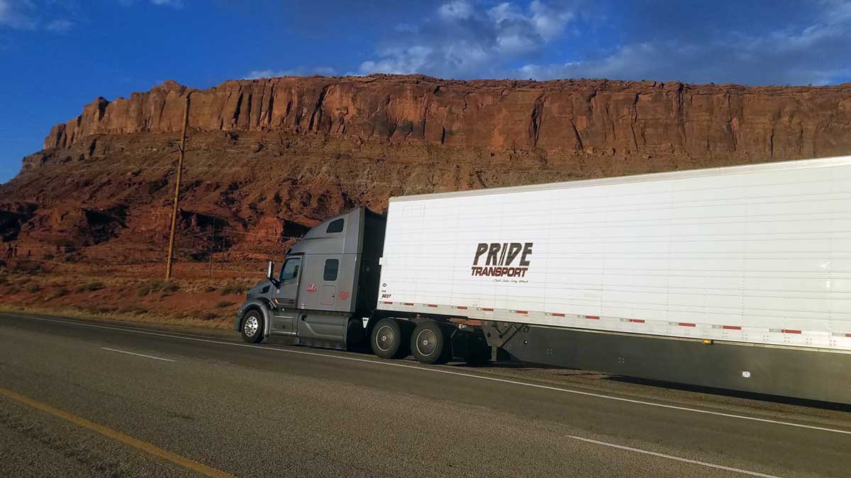 semi truck parked by red rock