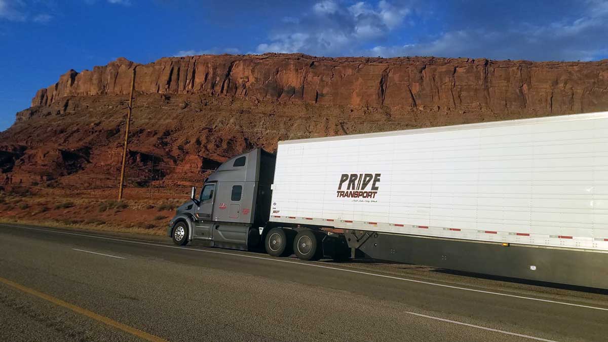 truck driving on sunset road