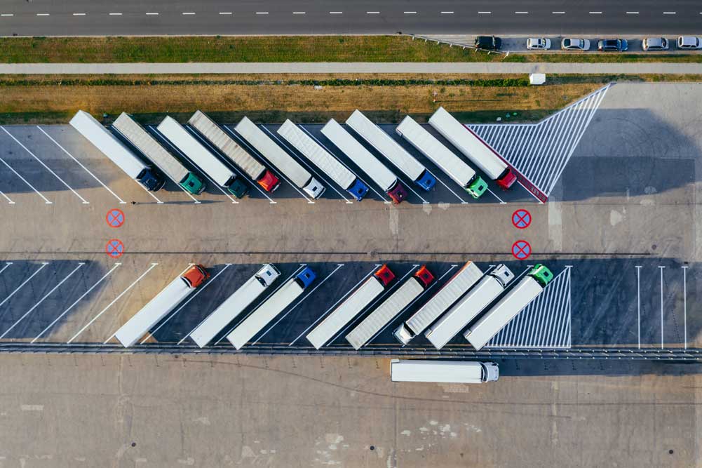birds eye view of semi trucks parked in a truck stop
