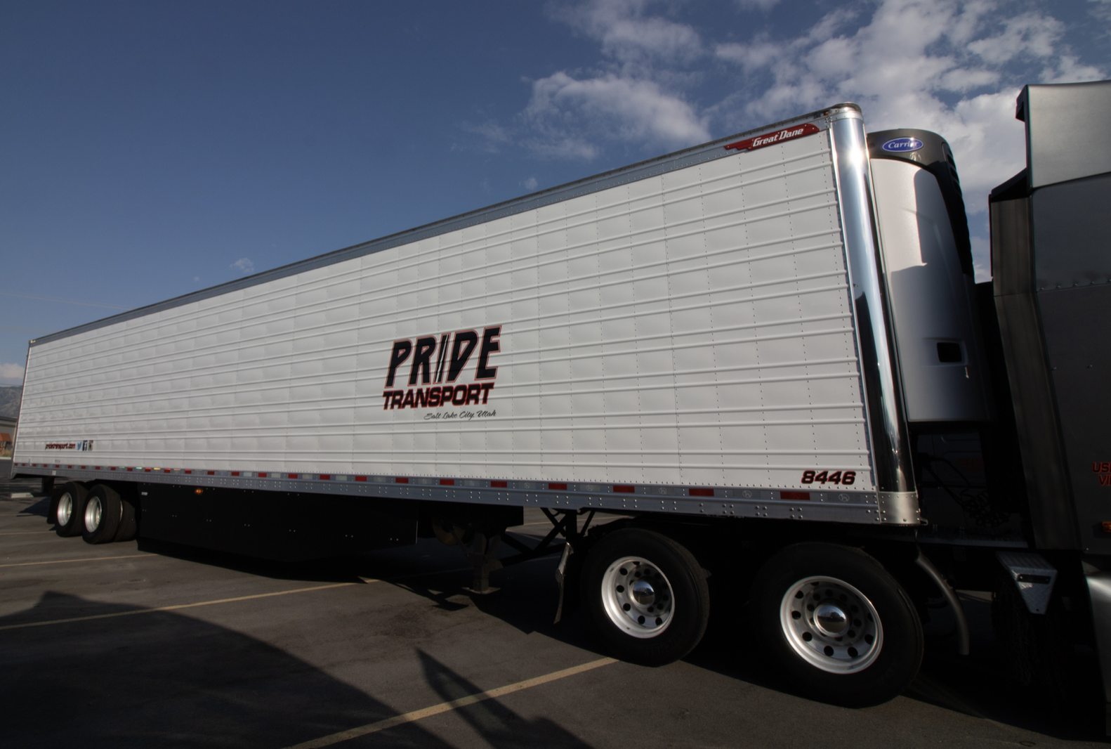 view of pride transport truck trailer from the side