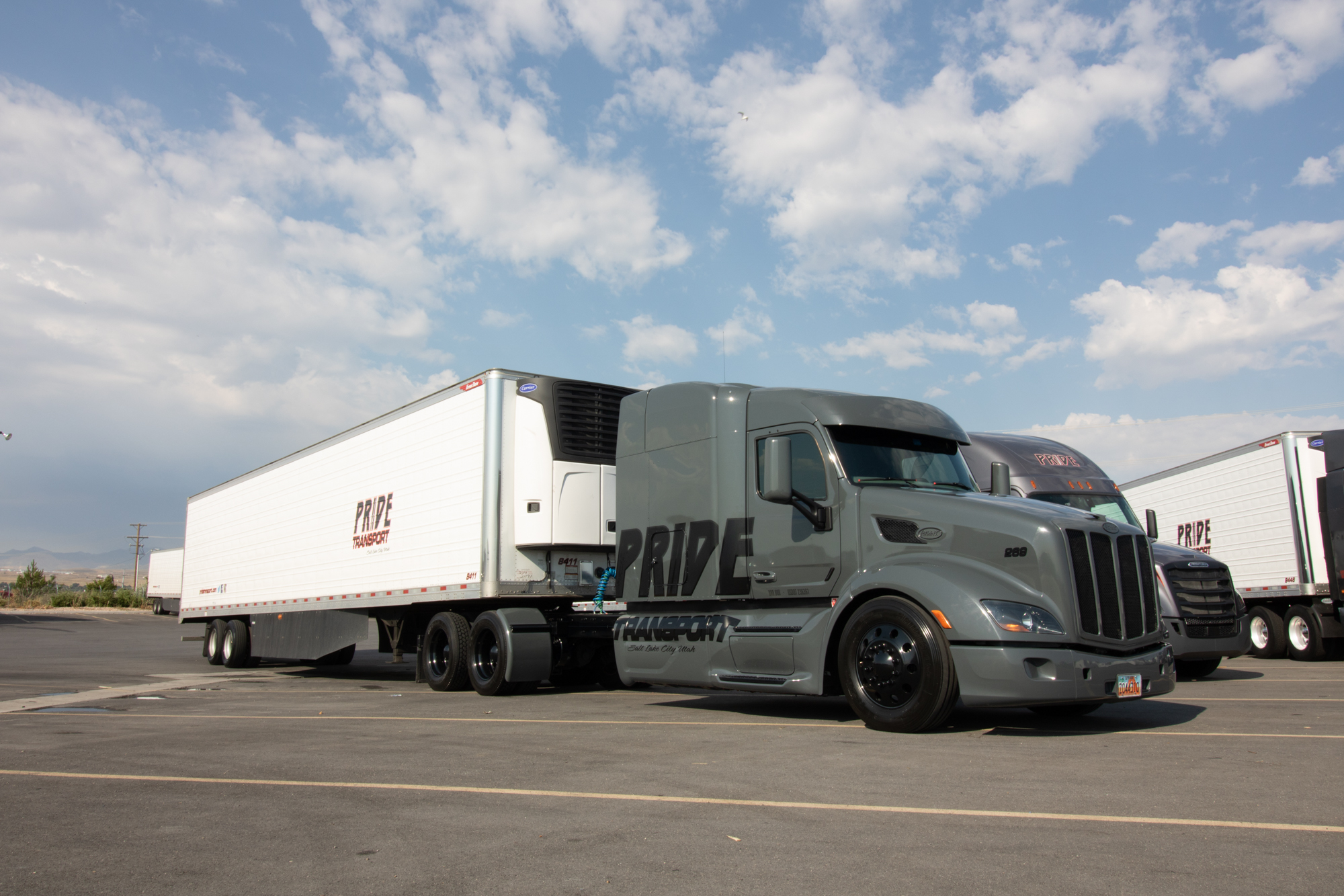 pride transport truck sitting in an empty parking lot