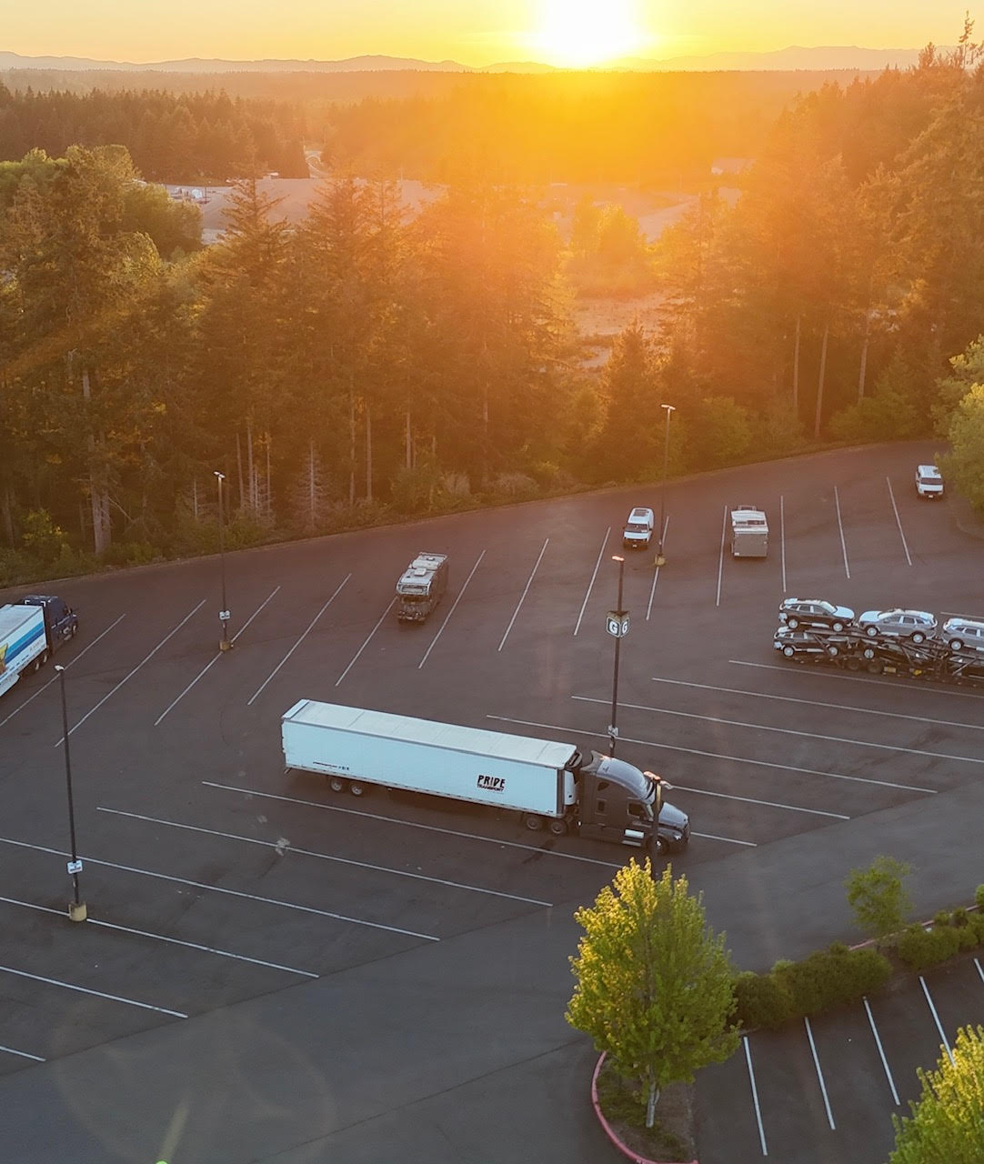 overhead drone photo of pride transport truck with mount rainier in background
