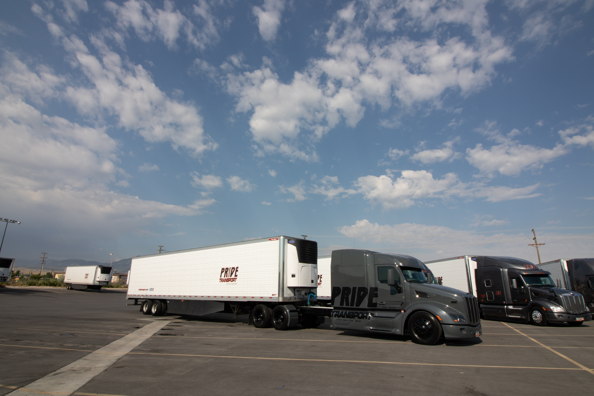 side view of pride transport truck parked in lot