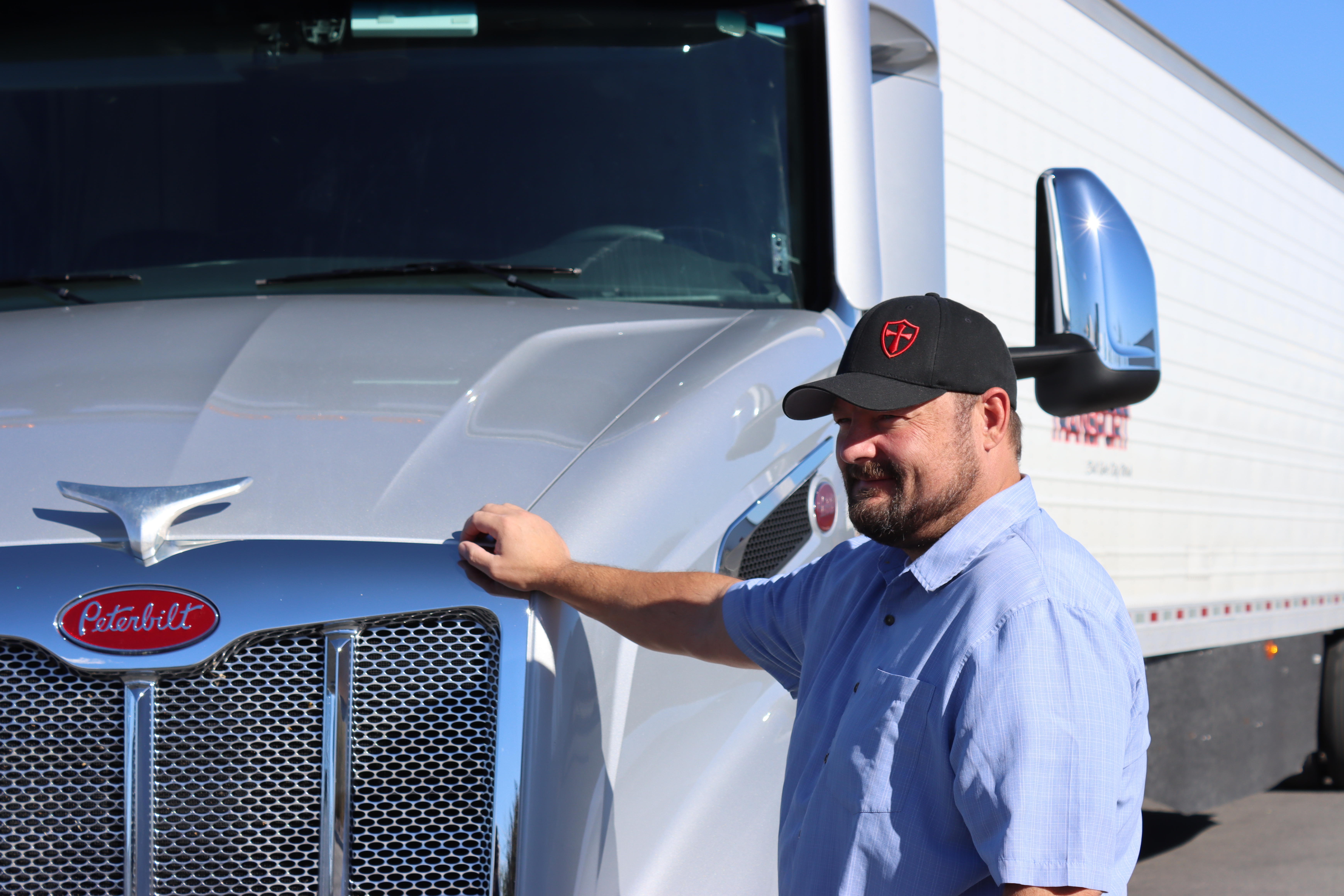 pride transport driver posed by truck