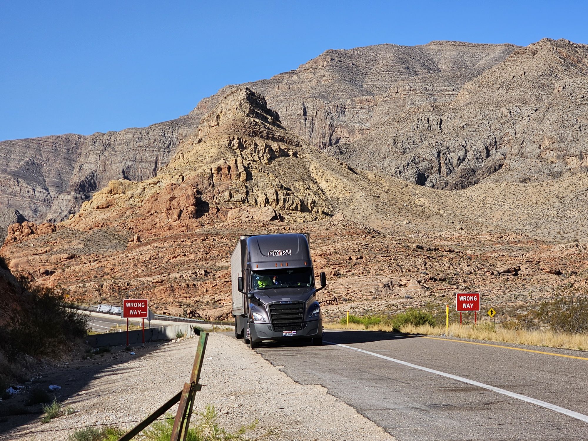 pride transport truck with red rock landscape in background