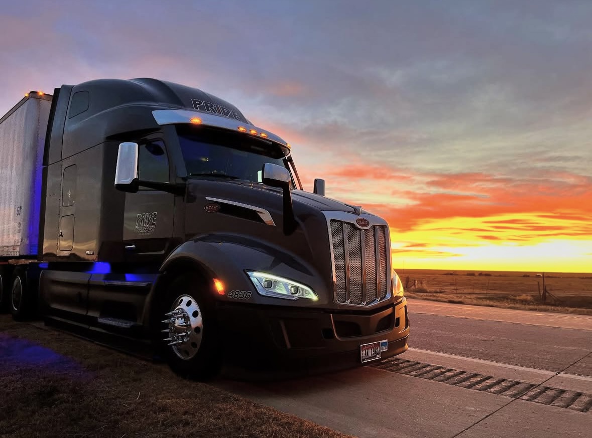 front corner of pride transport truck with sunset in background