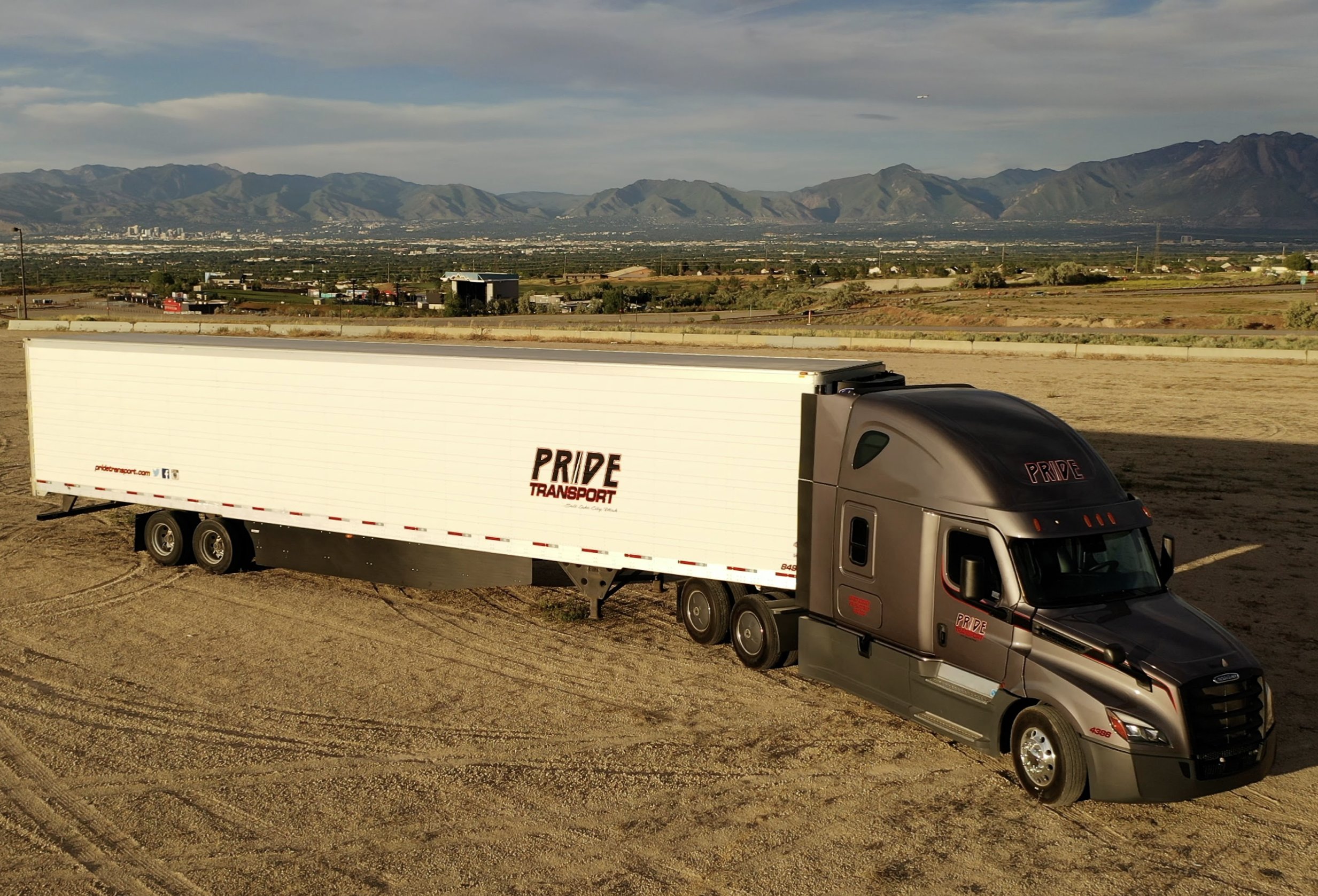 pride transport truck parked in field