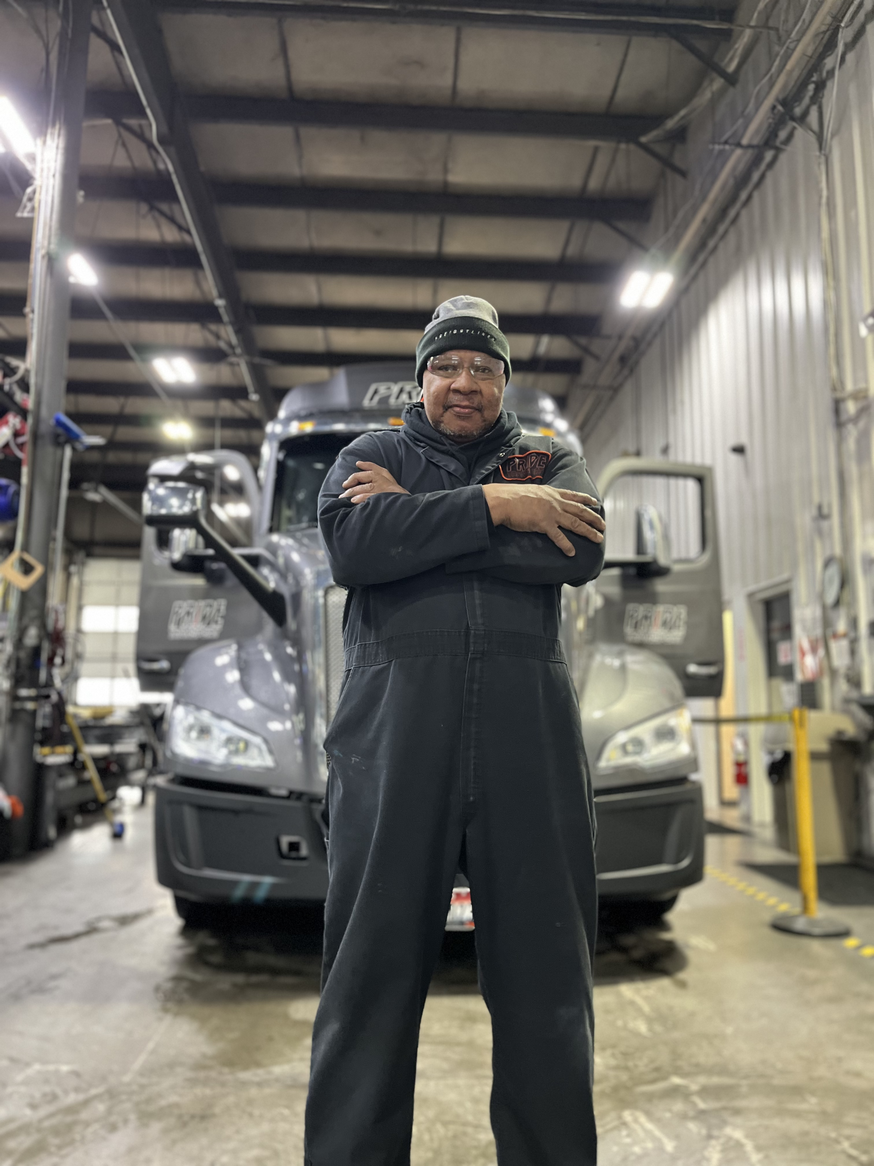 pride transport mechanic in front of truck