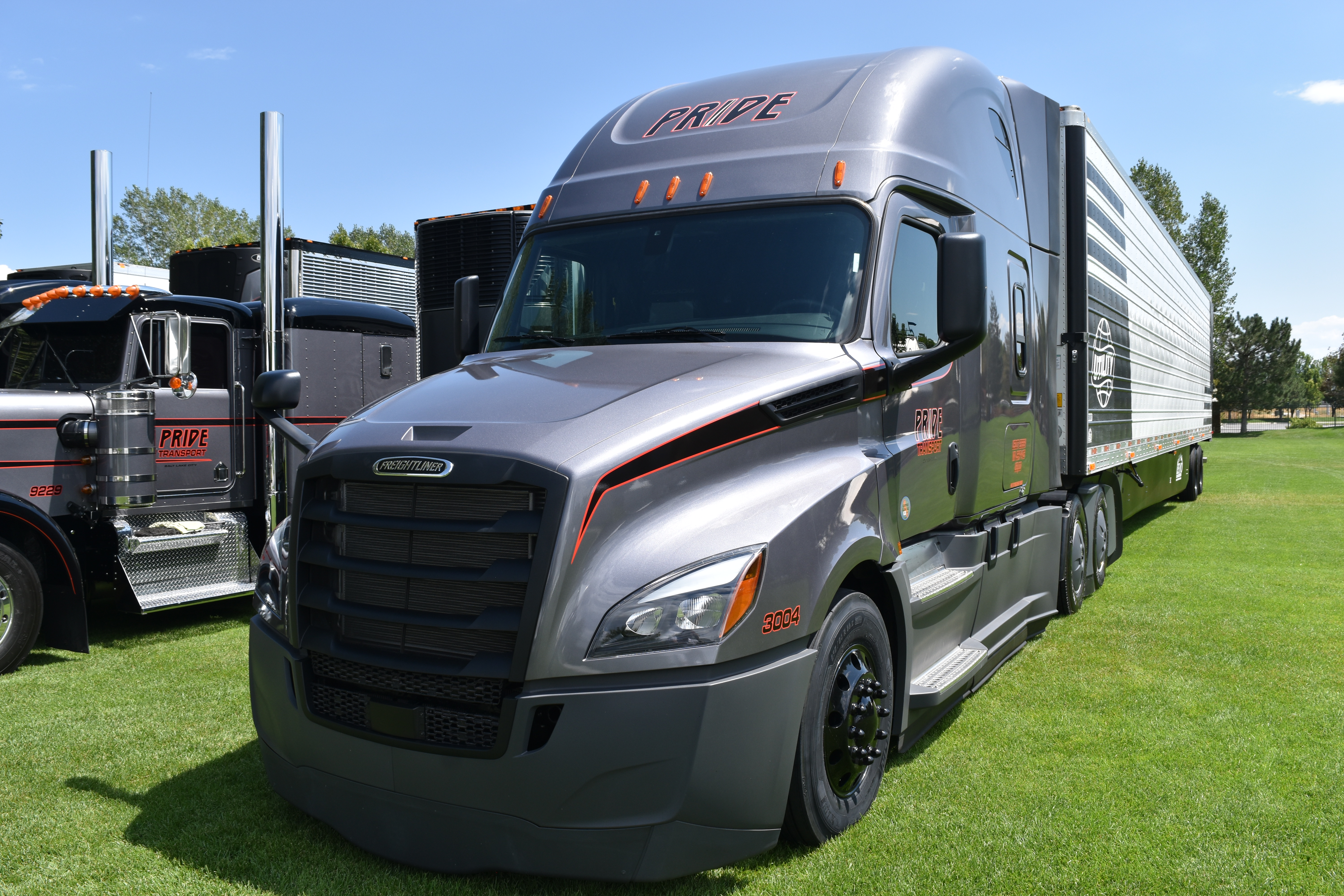 pride transport truck parked in grass