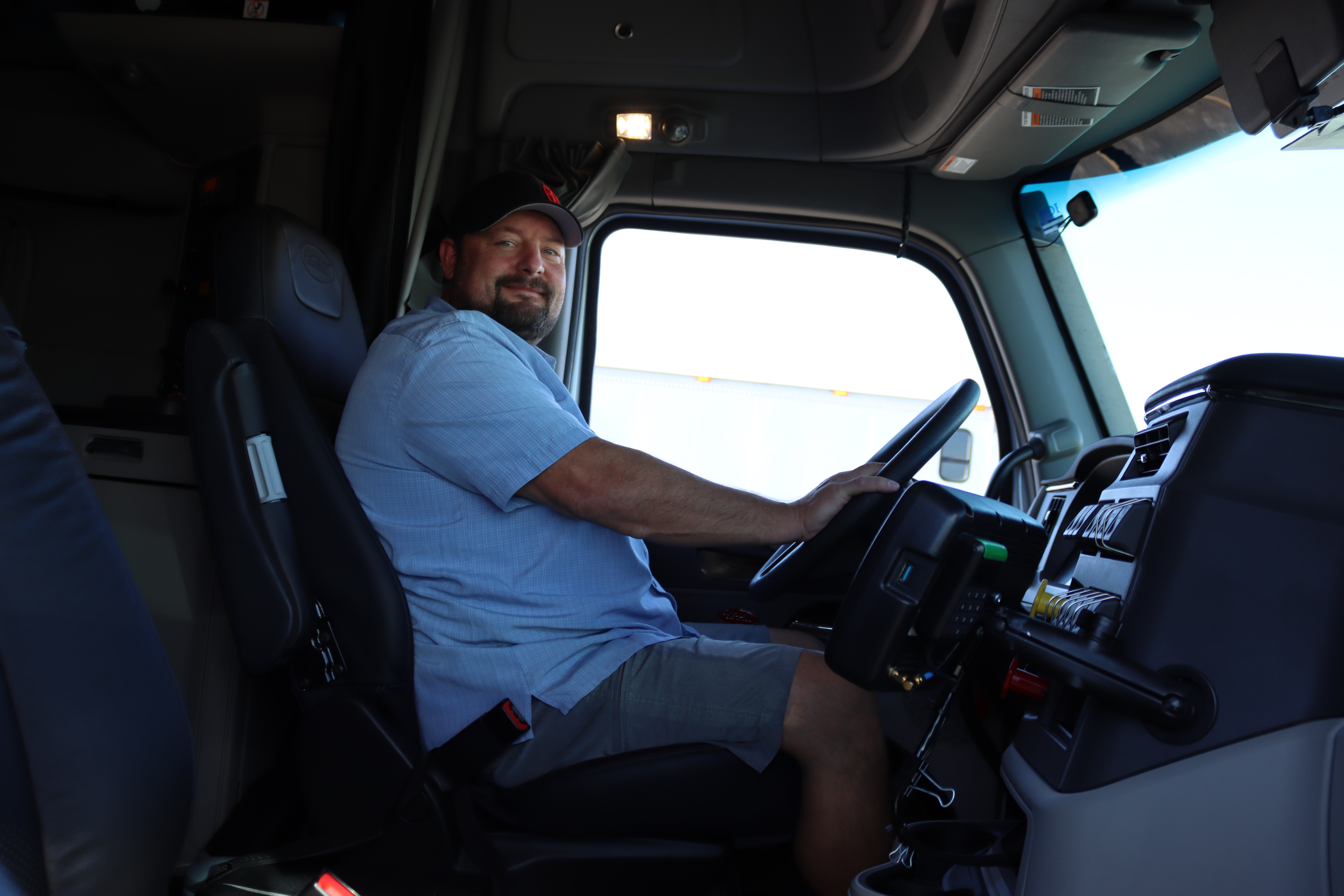 pride transport employee driving truck