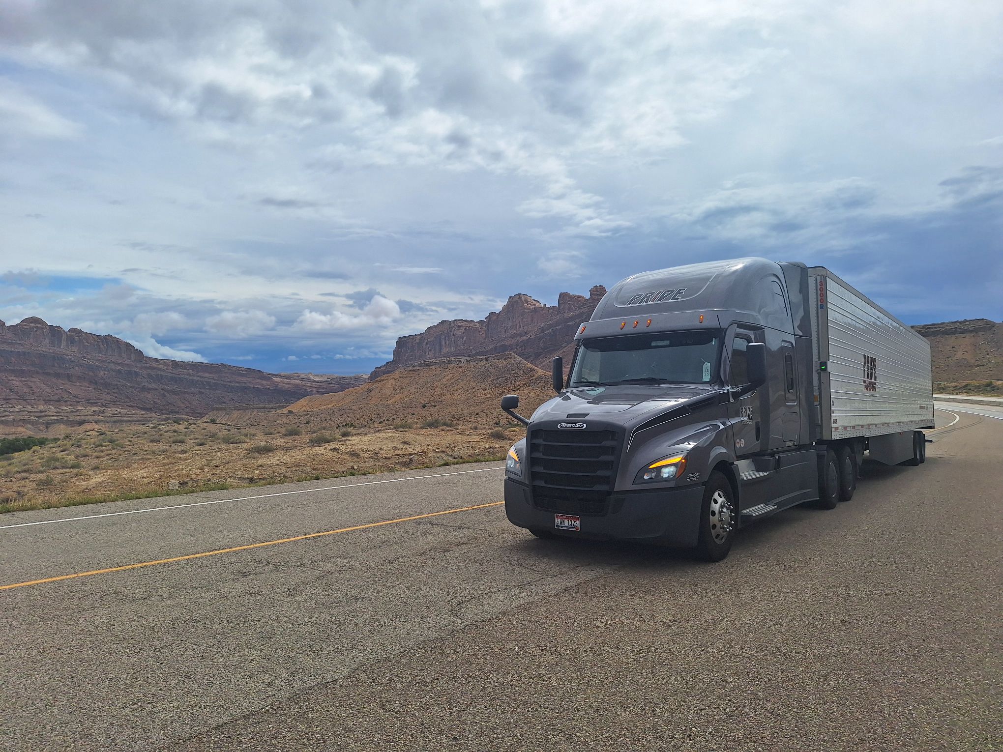 pride transport truck in front of canyon scenery