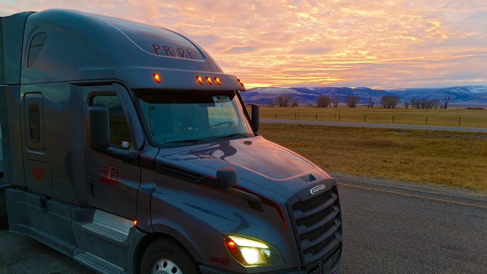 pride transport truck with sunset in background