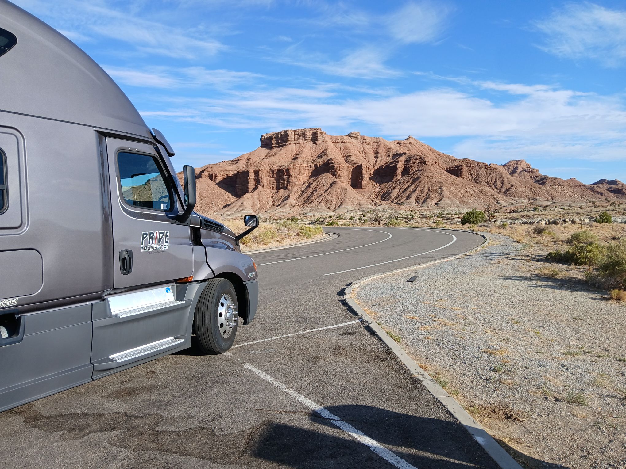 pride transport truck parked on shoulder in desert location