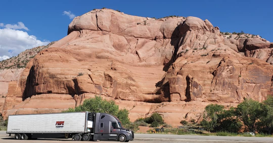 Pride truck in front of mountain