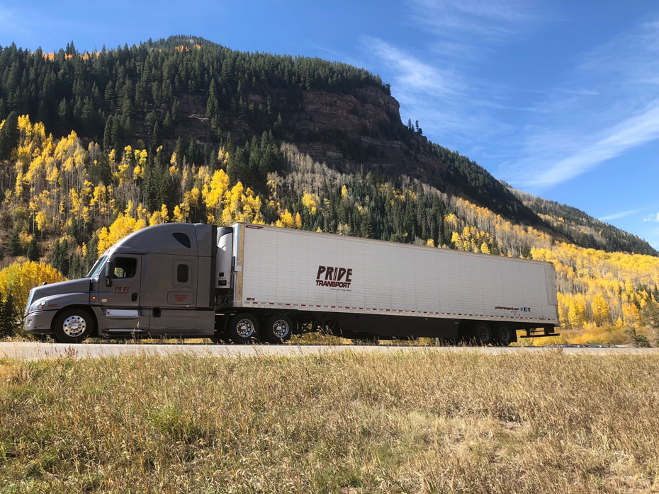 long haul truck driving through a canyon