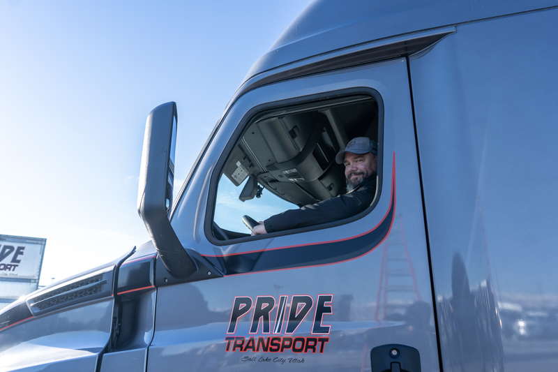 pride transport driver smiling out of truck window
