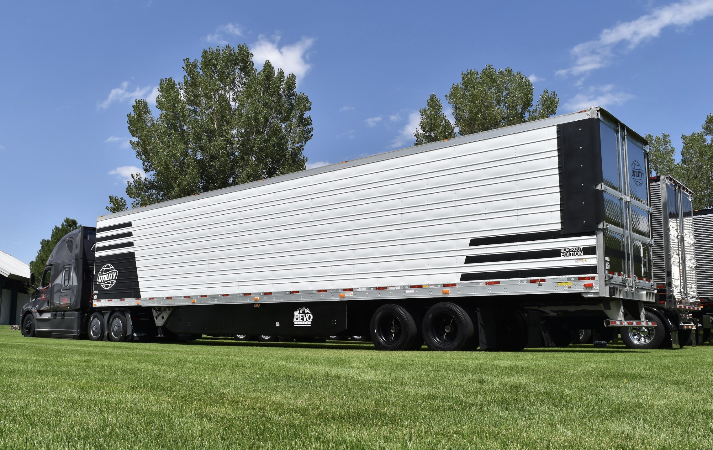 pride transport truck parked in grass