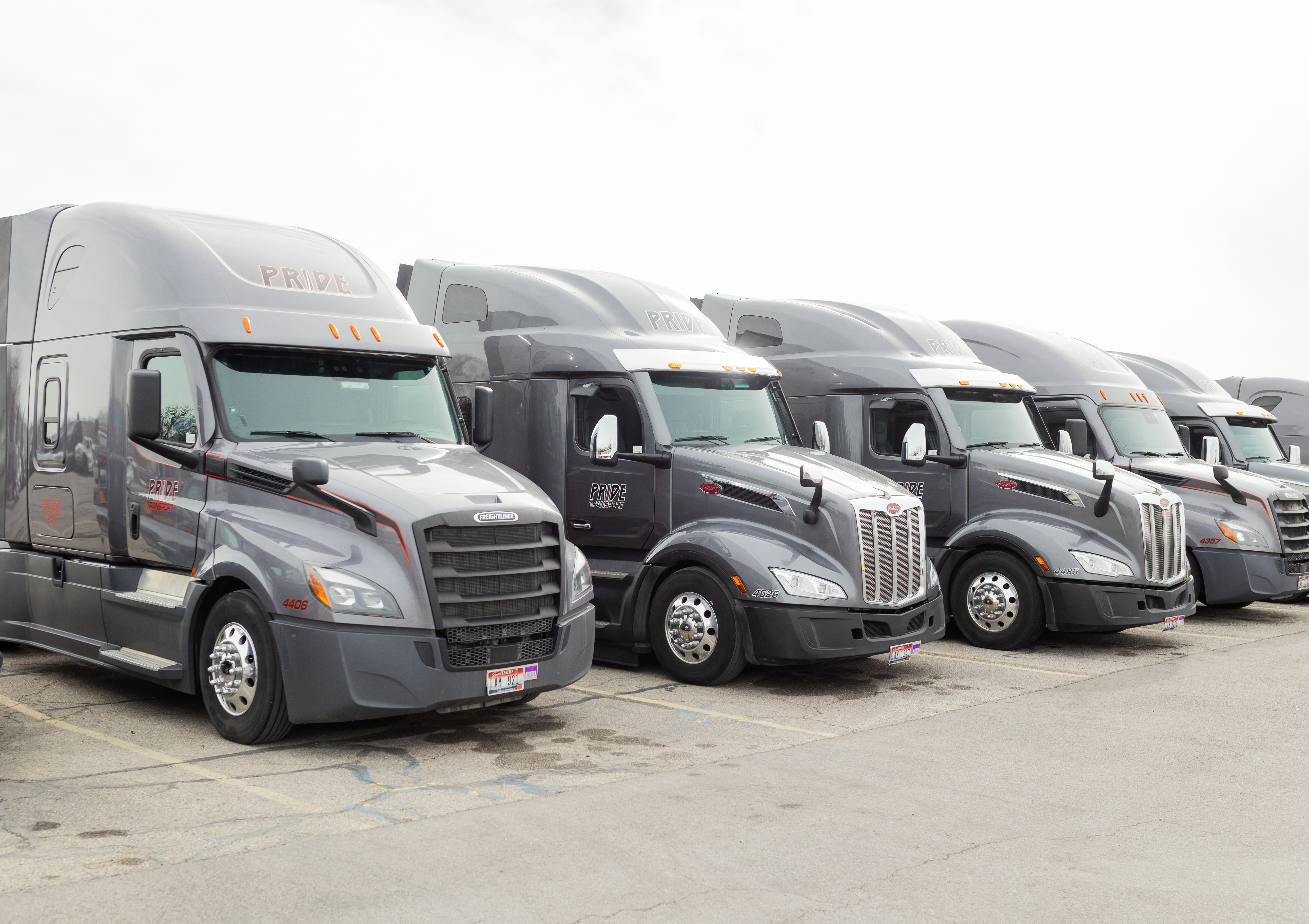 pride transport trucks parked together