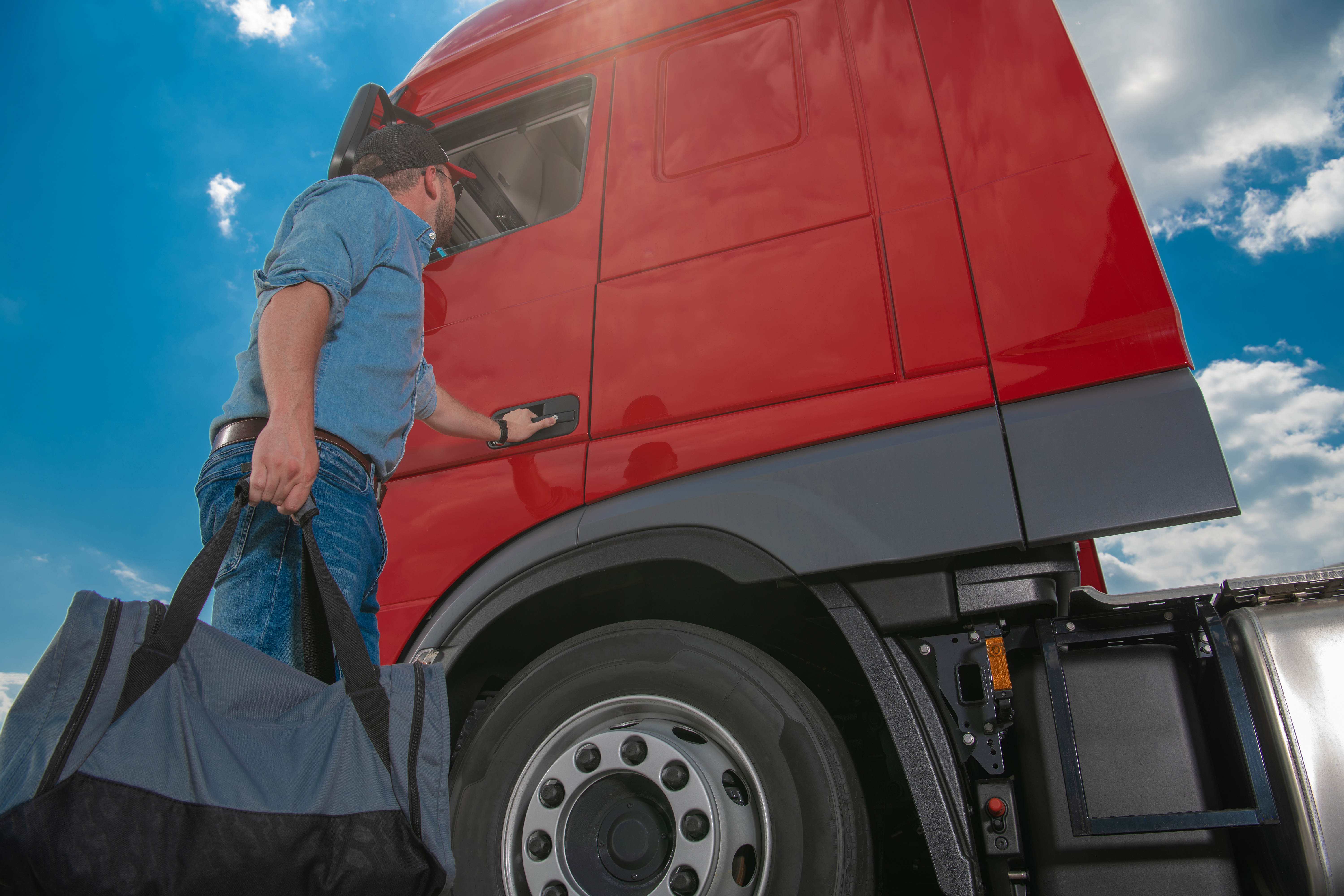 guy getting into truck with bag in hand