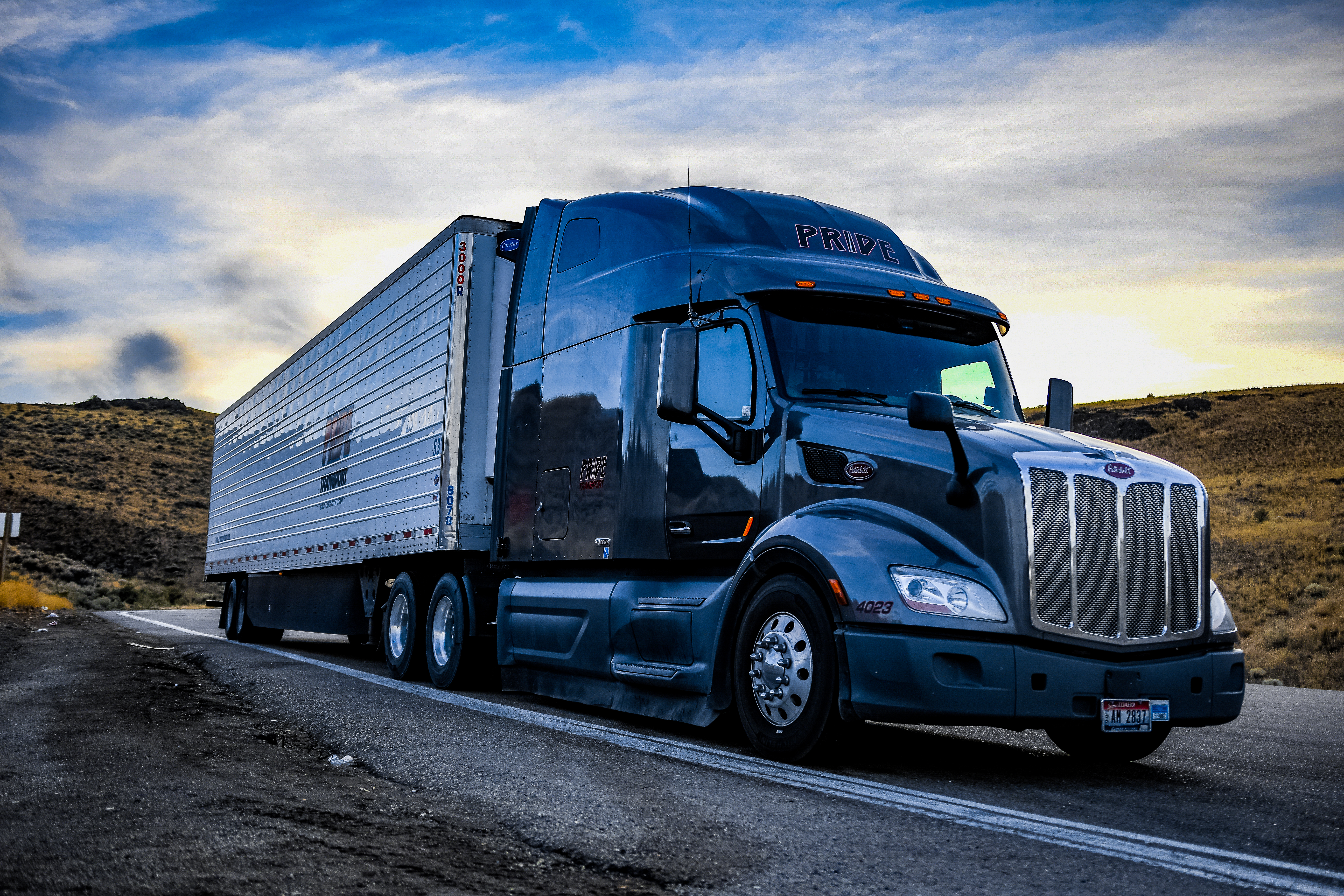 pride transport truck parked on side of road