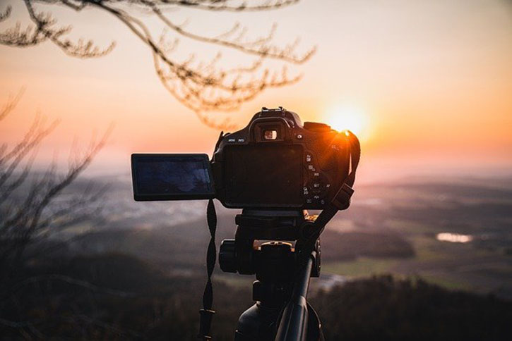 camera focused on orange sunset