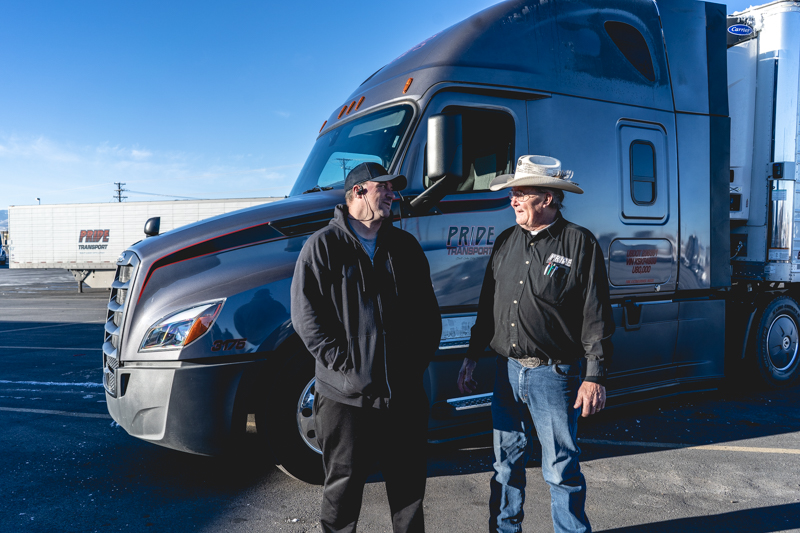 truck drivers walking back to 18 wheeler