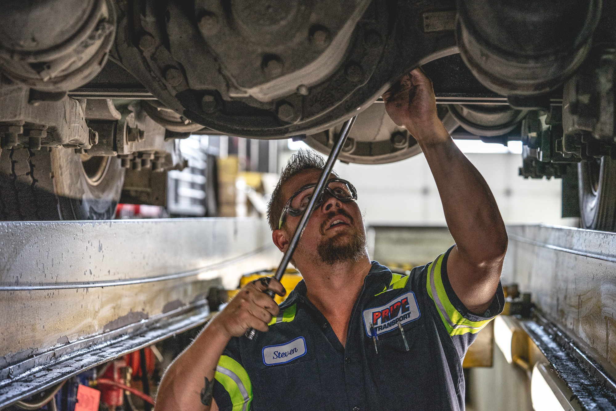 pride transport shop employee working on a truck