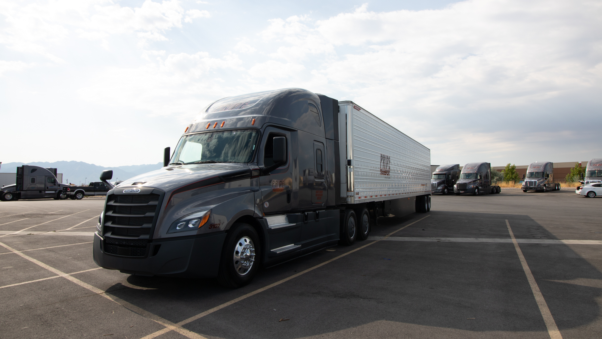 pride transport truck parking in the middle of their parking lot