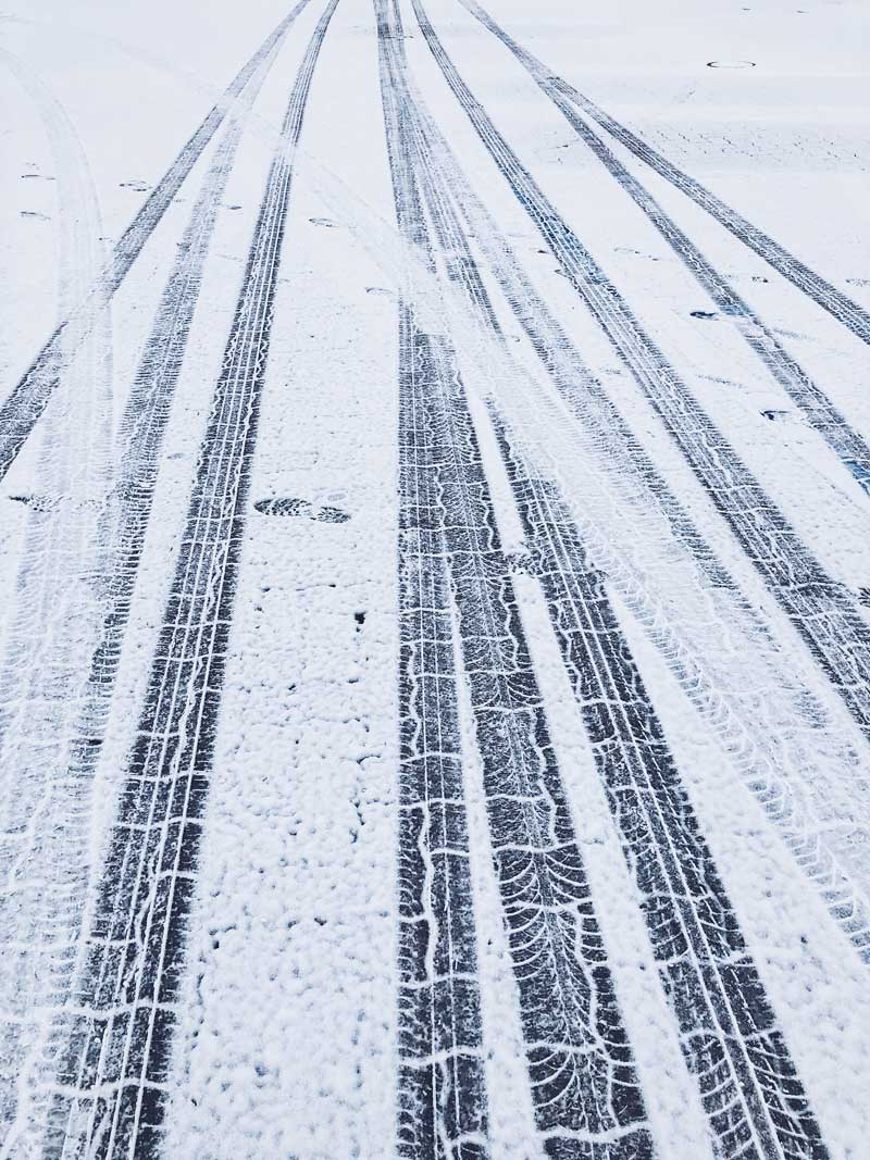 tire tracks on a road in the snow