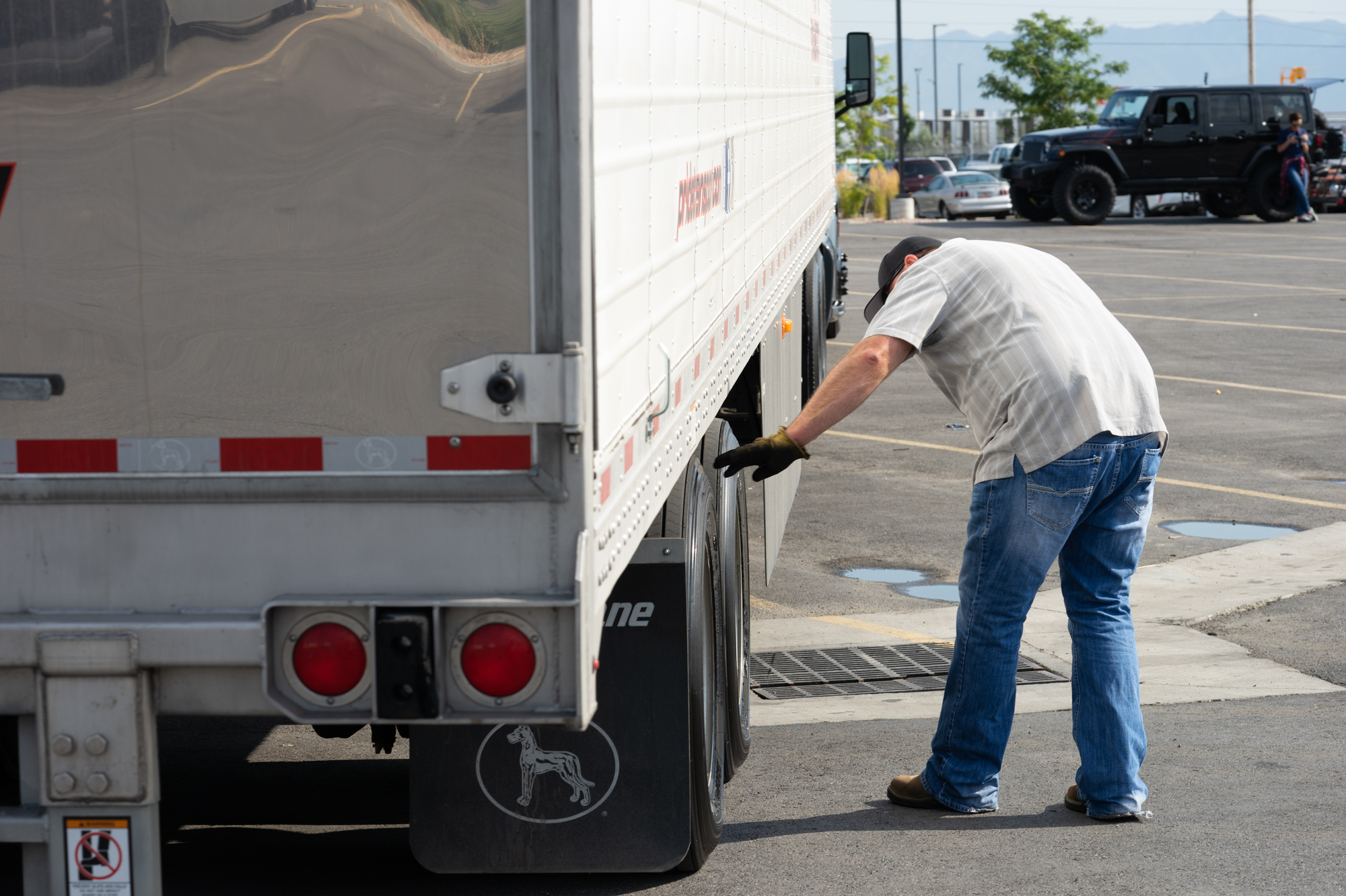 pride transport driver checking tire tread