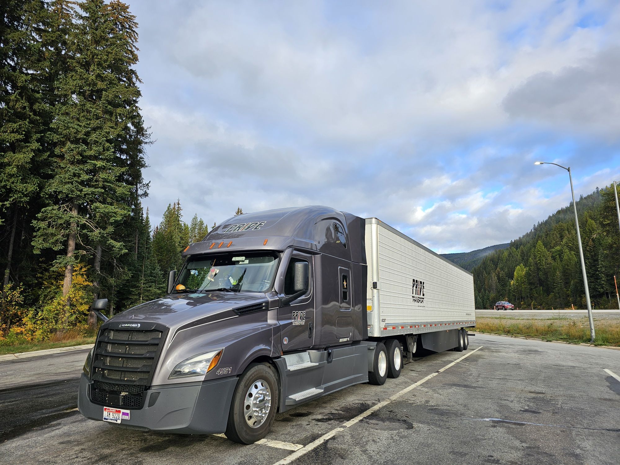 pride transport truck with nature in background