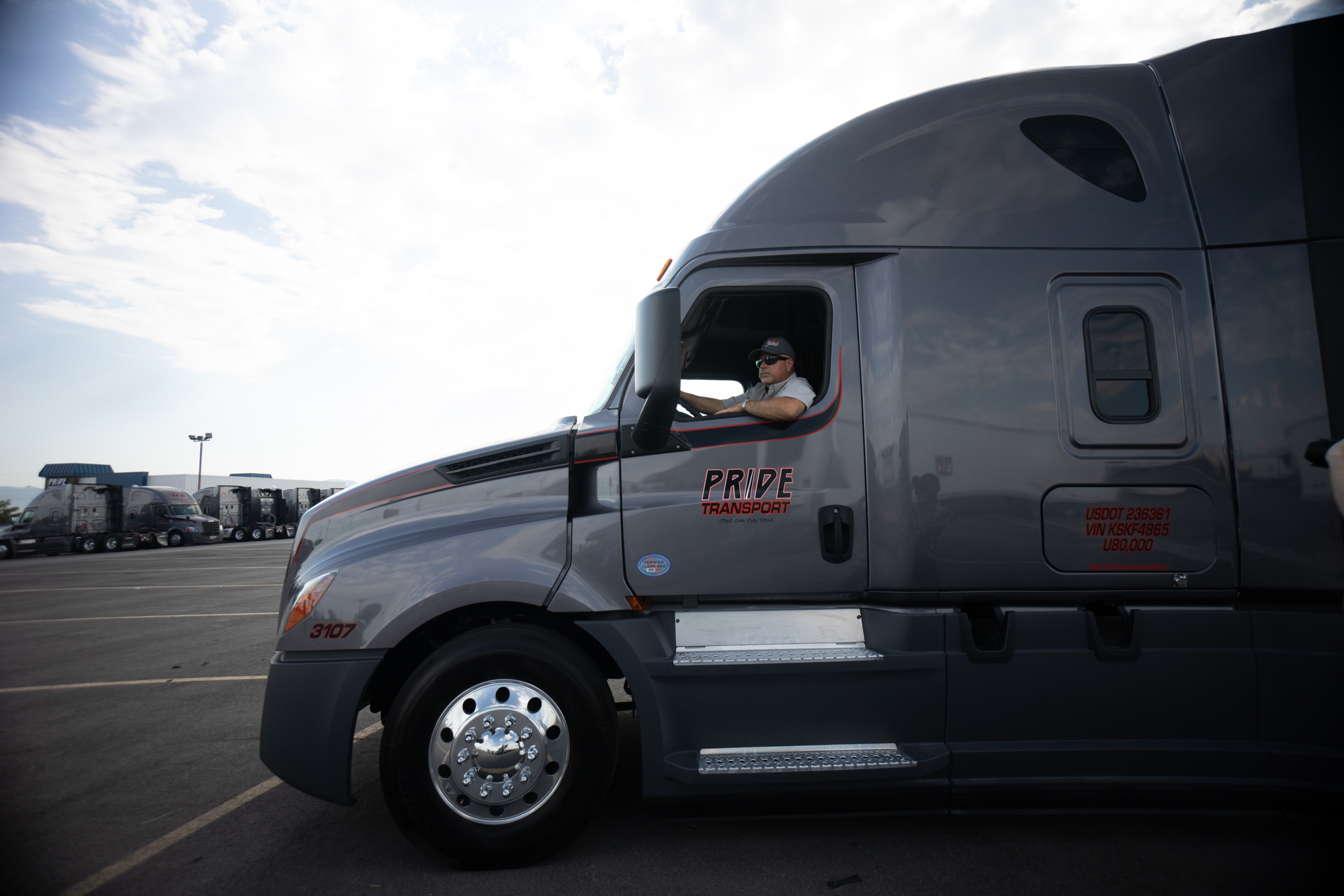 pride transport employee checking tire tread depth