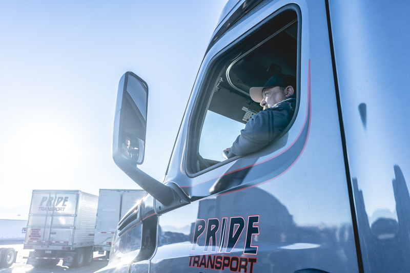 pride transport employee driving truck