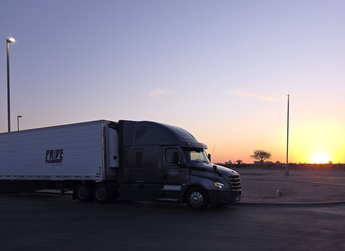 Pride Transport truck parked with sunset in background