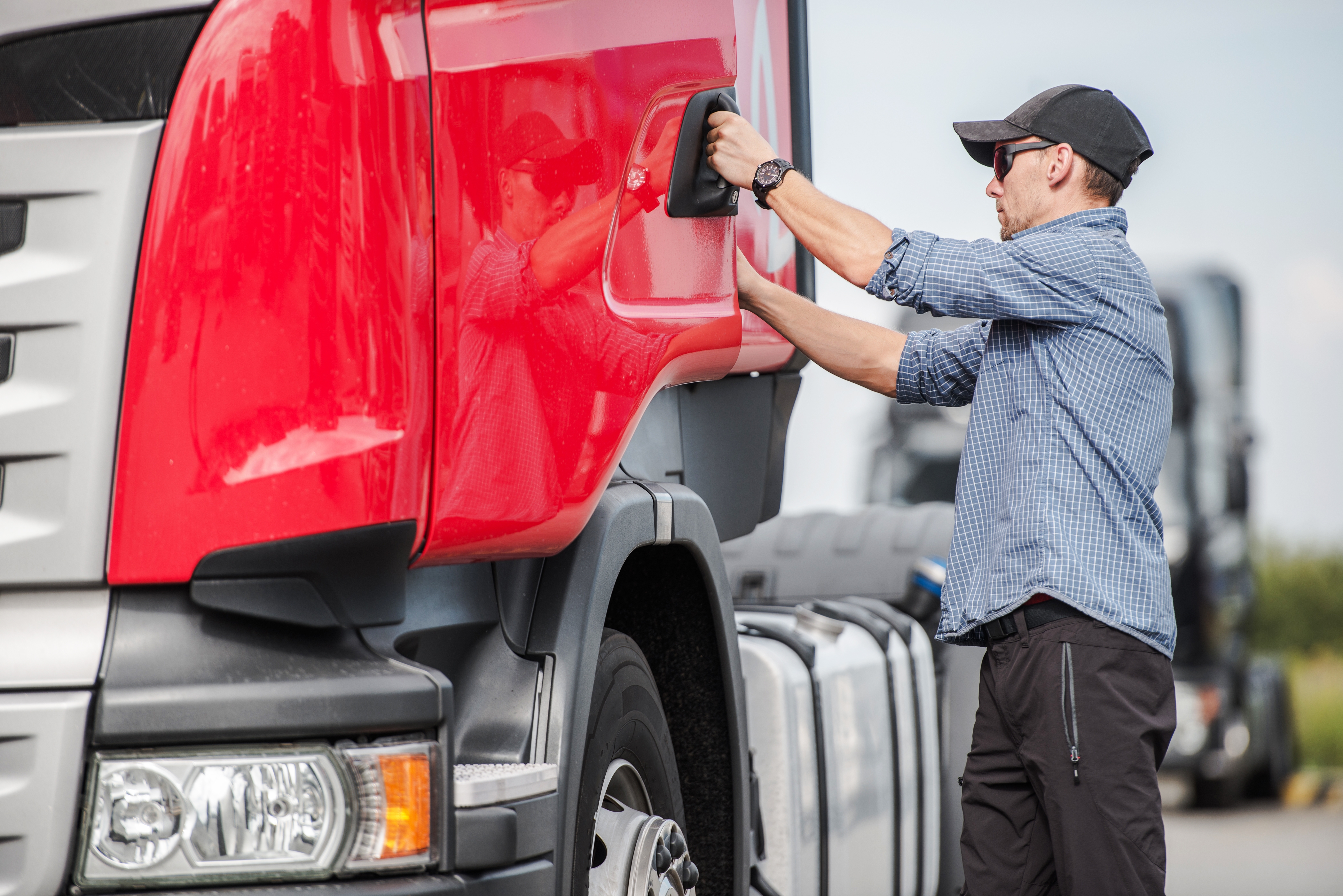 truck driver opening up the drivers side door and getting in