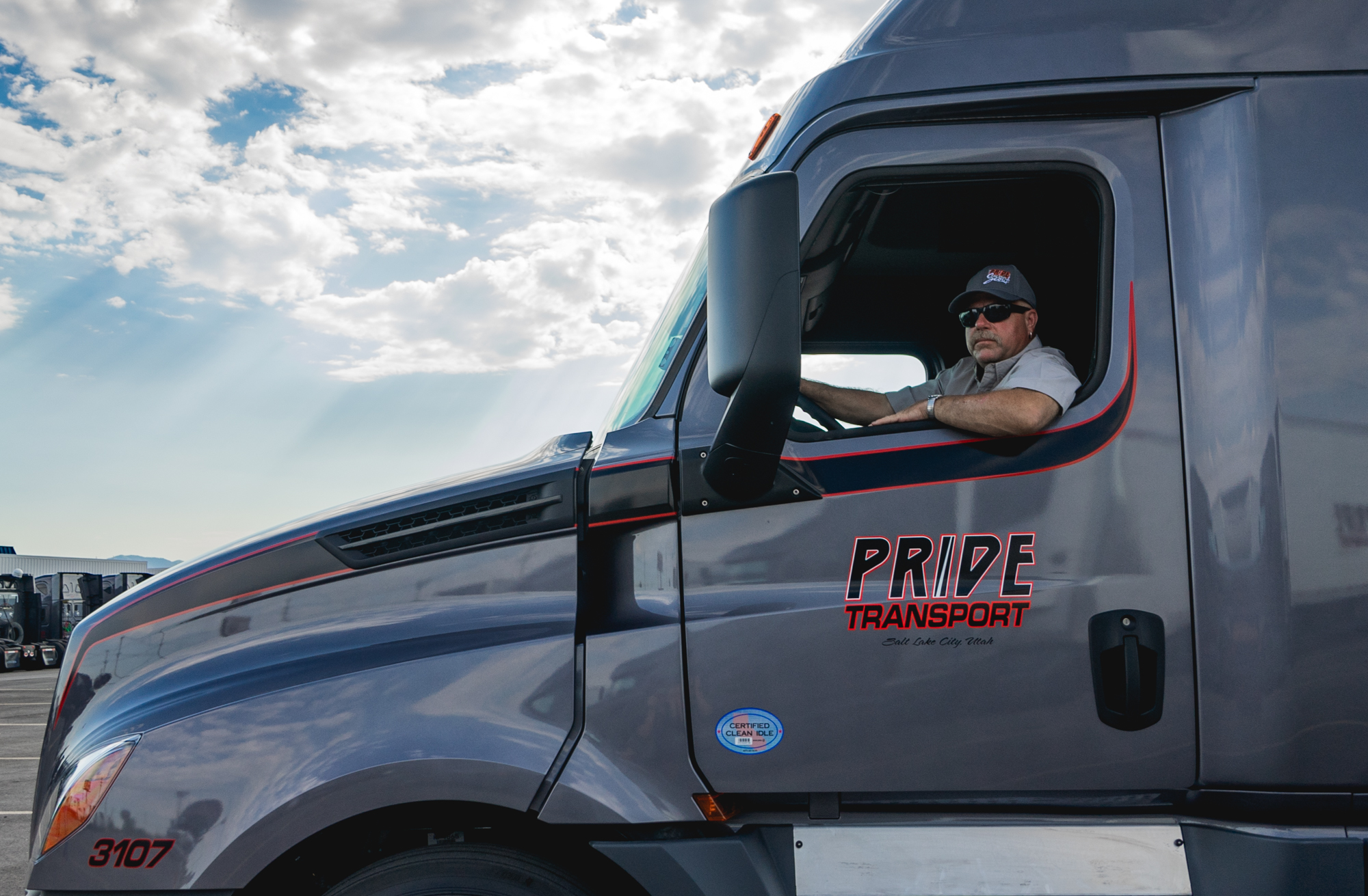 pride transport employee in drivers seat smiling