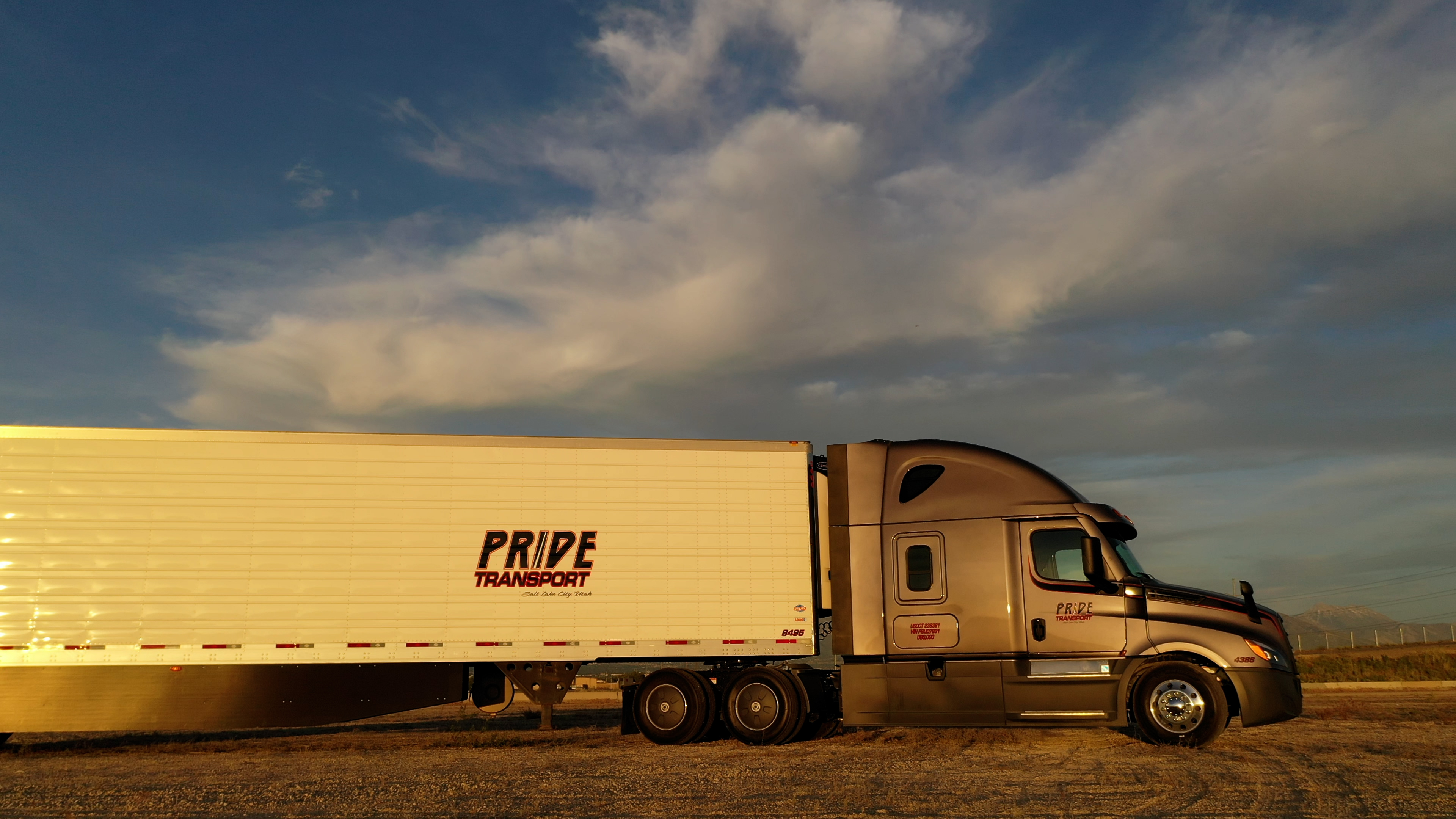 pride transport truck parked in open lot